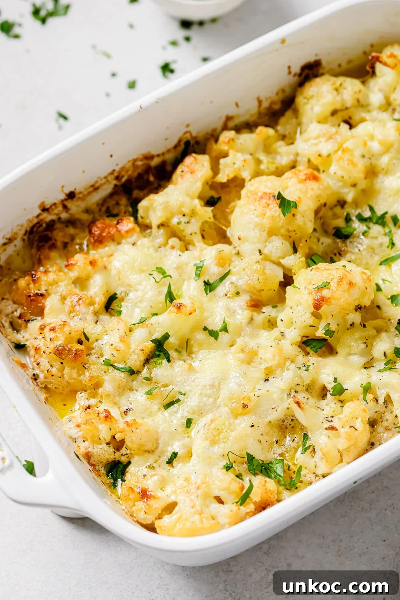 Creamy Cauliflower Au Gratin with Golden Cheese Crust 2 Close up of cauliflower au gratin in a baking dish.