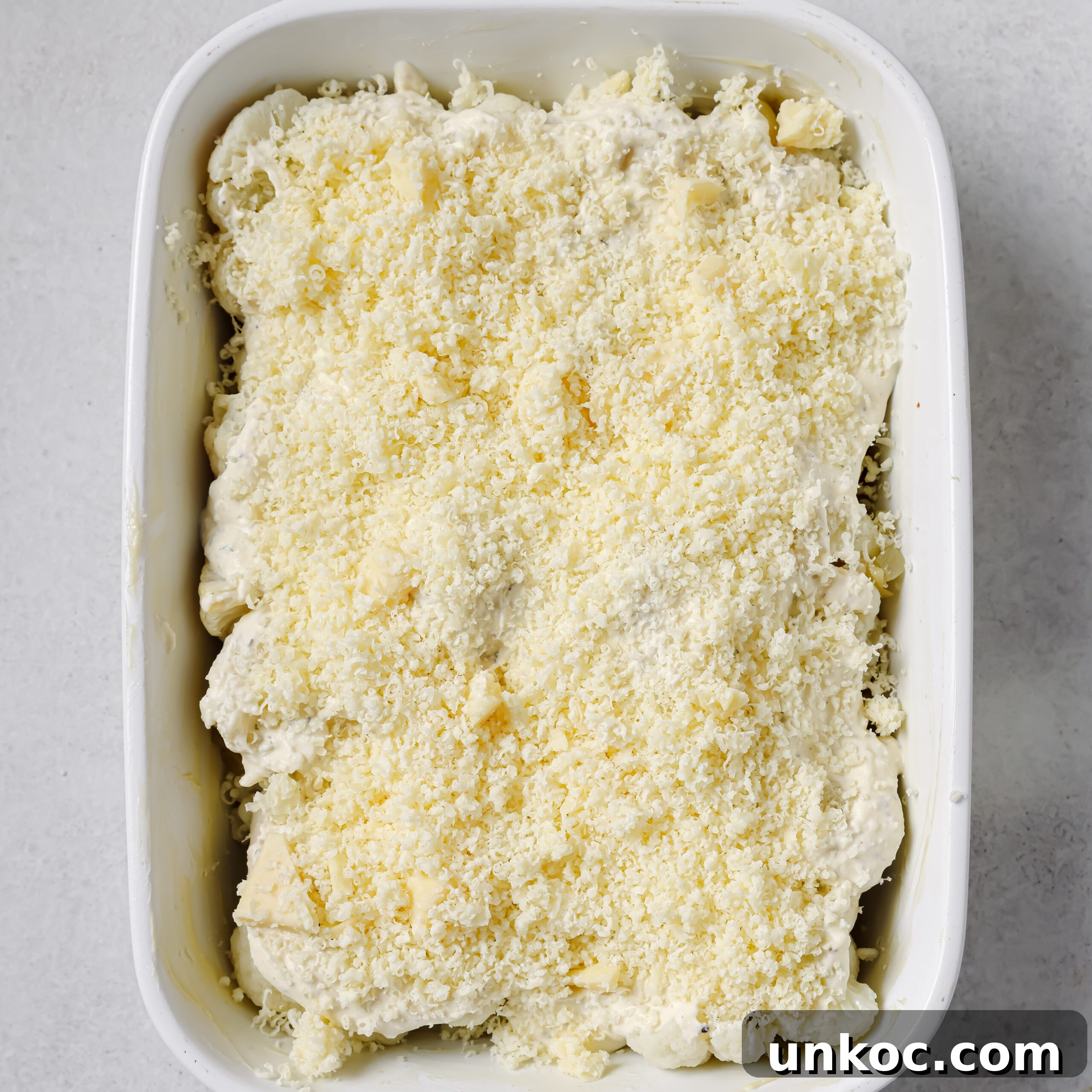 Creamy Cauliflower Au Gratin with Golden Cheese Crust 10 Cheese sprinkled over cauliflower gratin.