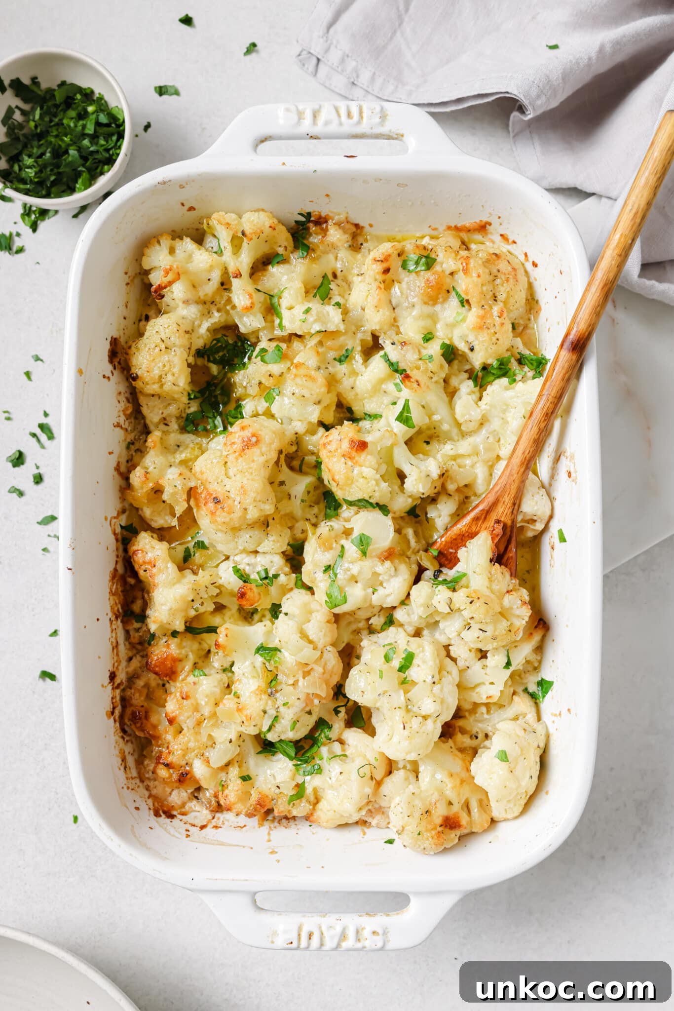Creamy Cauliflower Au Gratin with Golden Cheese Crust 12 Close up of cauliflower au gratin in a baking dish.
