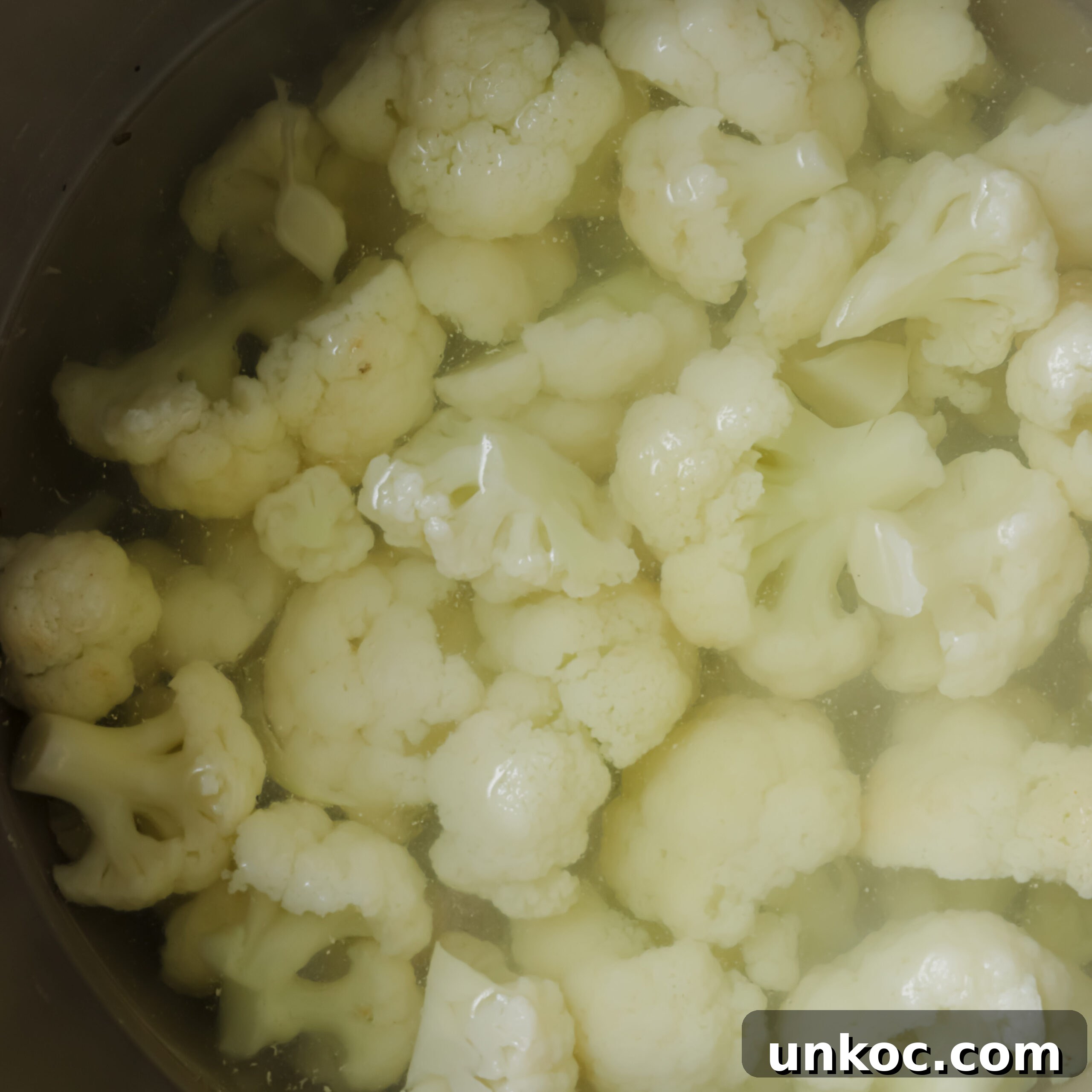 Creamy Cauliflower Au Gratin with Golden Cheese Crust 4 Cauliflower in a pot of water.