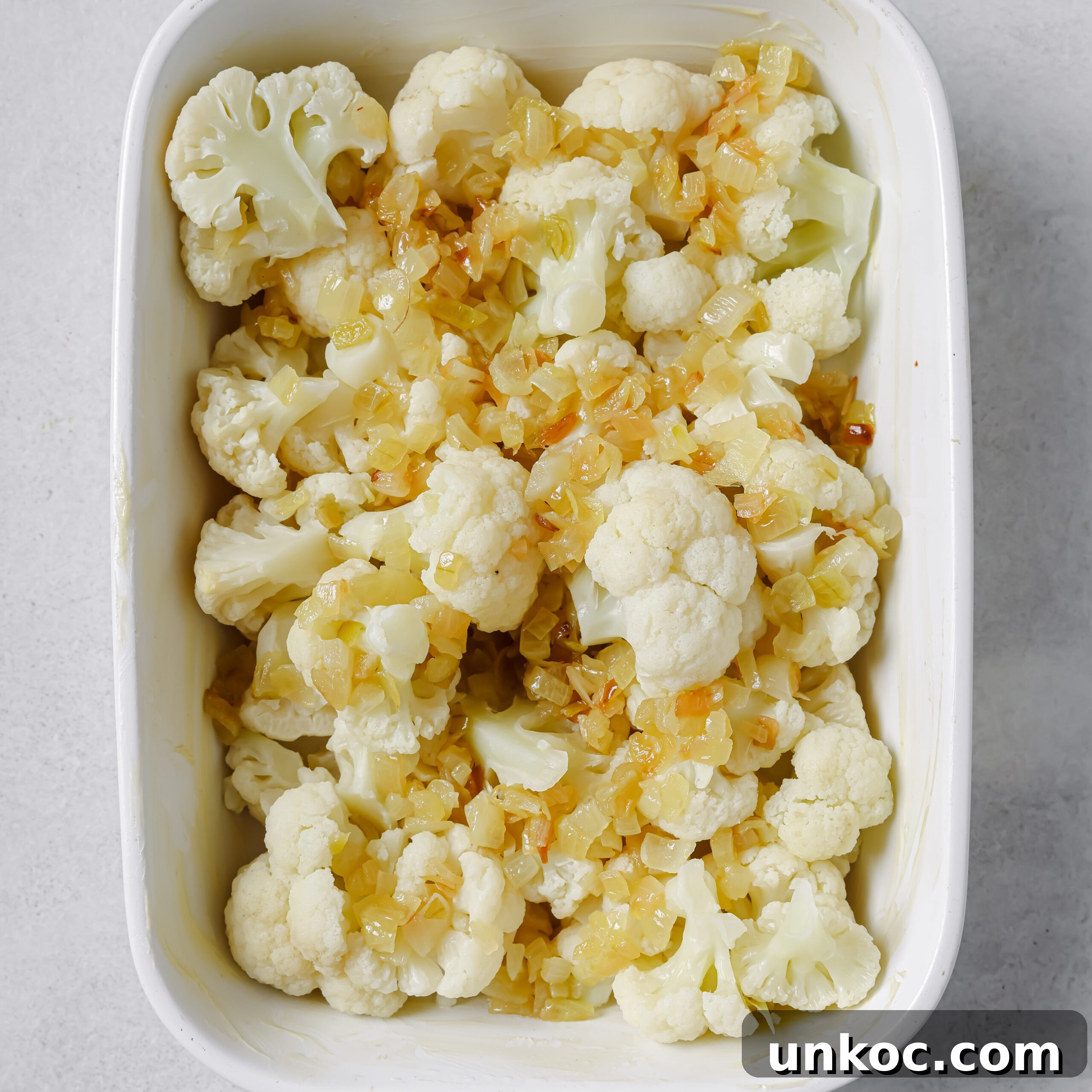 Creamy Cauliflower Au Gratin with Golden Cheese Crust 8 Cauliflower arranged in a baking dish.