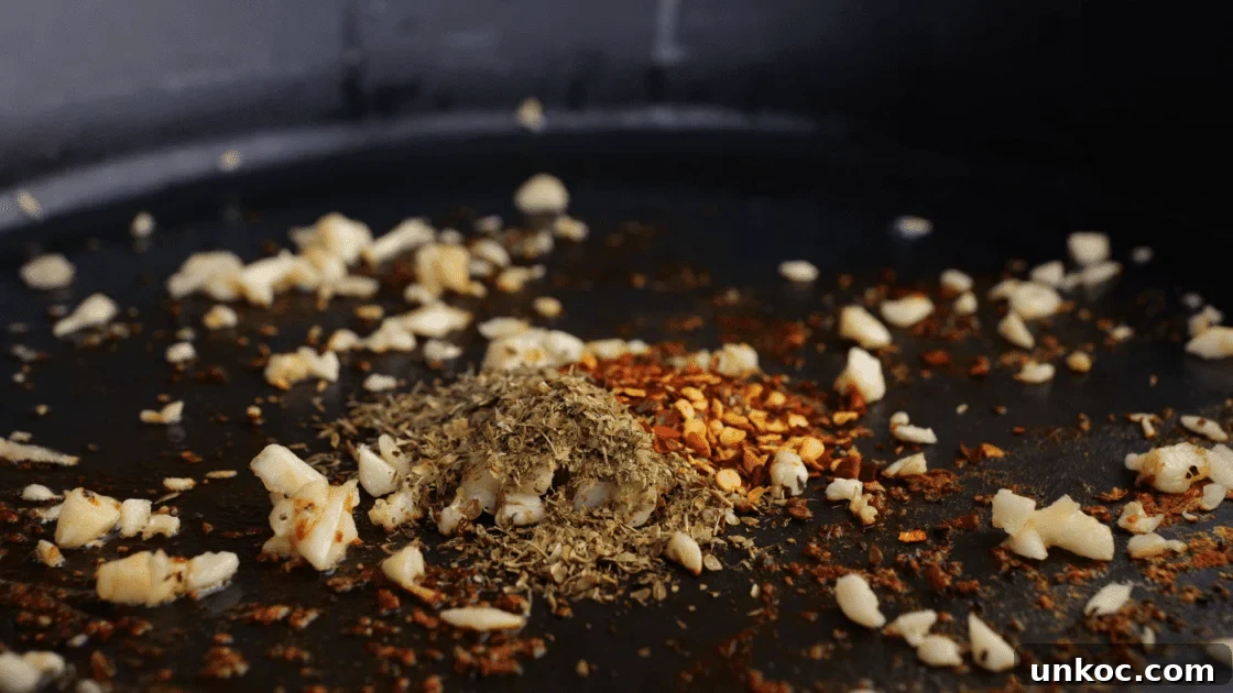 Add garlic and seasonings to skillet next.