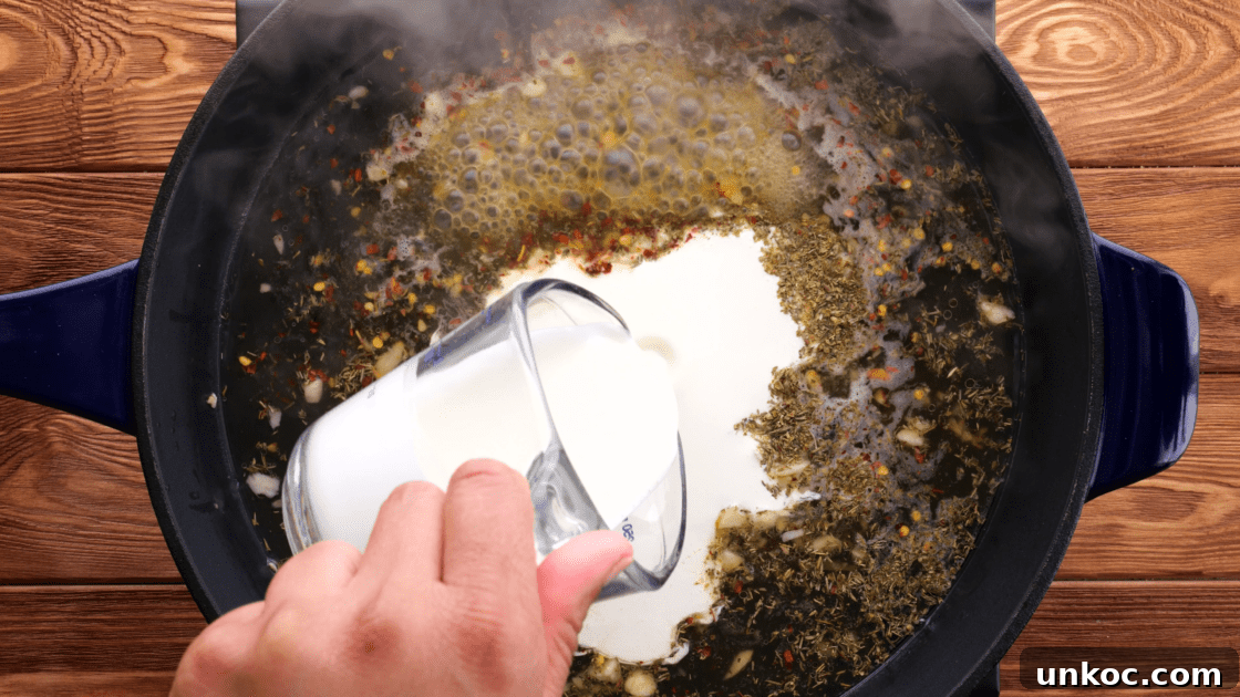 Add heavy cream to the skillet.