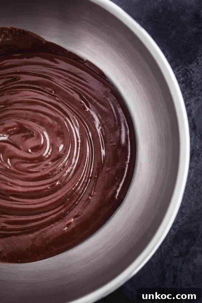 Chocolate Tahini Tart Recipe with Silky Ganache 11 Chocolate ganache is mixed together.