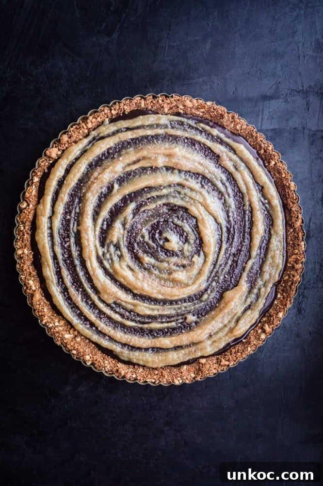Chocolate Tahini Tart Recipe with Silky Ganache 13 Finished tart with tahini swirl, overhead shot.