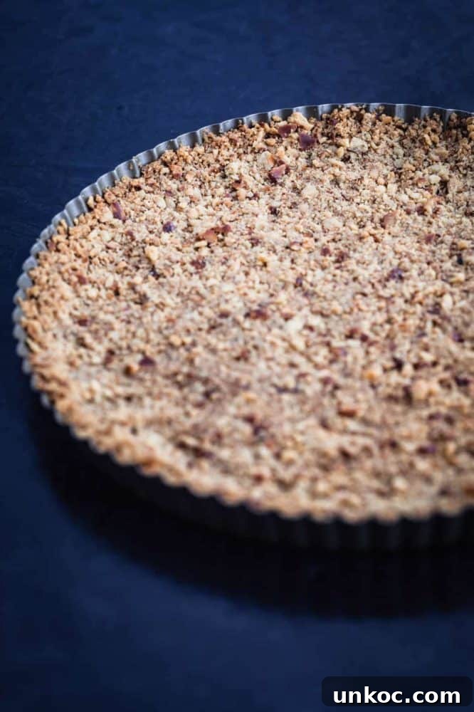 Chocolate Tahini Tart Recipe with Silky Ganache 7 Pretzel crust in tart pan, post oven, side angle shot.