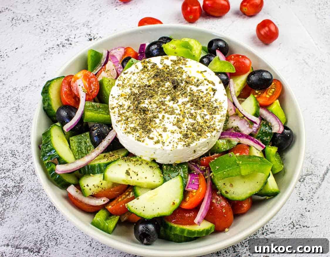 Greek Salad with a round block of feta in the middle.