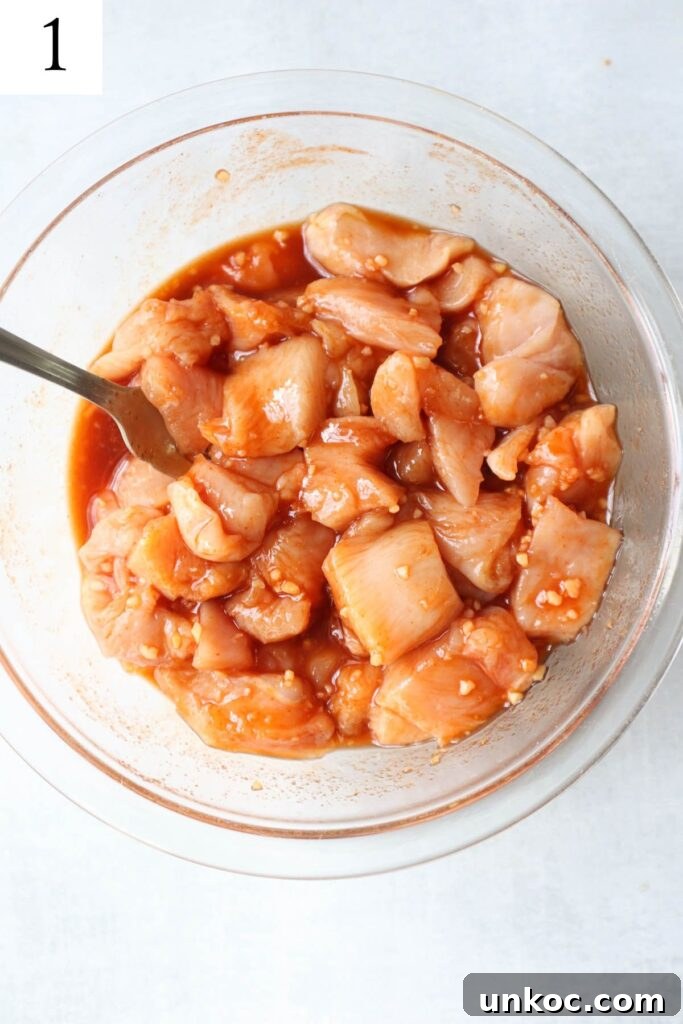 30 Minute Sriracha Chicken Wraps 4 glass bowl with chicken marinating in honey sriracha sauce.