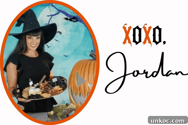 Smoked Blood Orange Margarita for Halloween 7 Jordan from Jordan's Easy Enteraining holding a Halloween charcuterie board