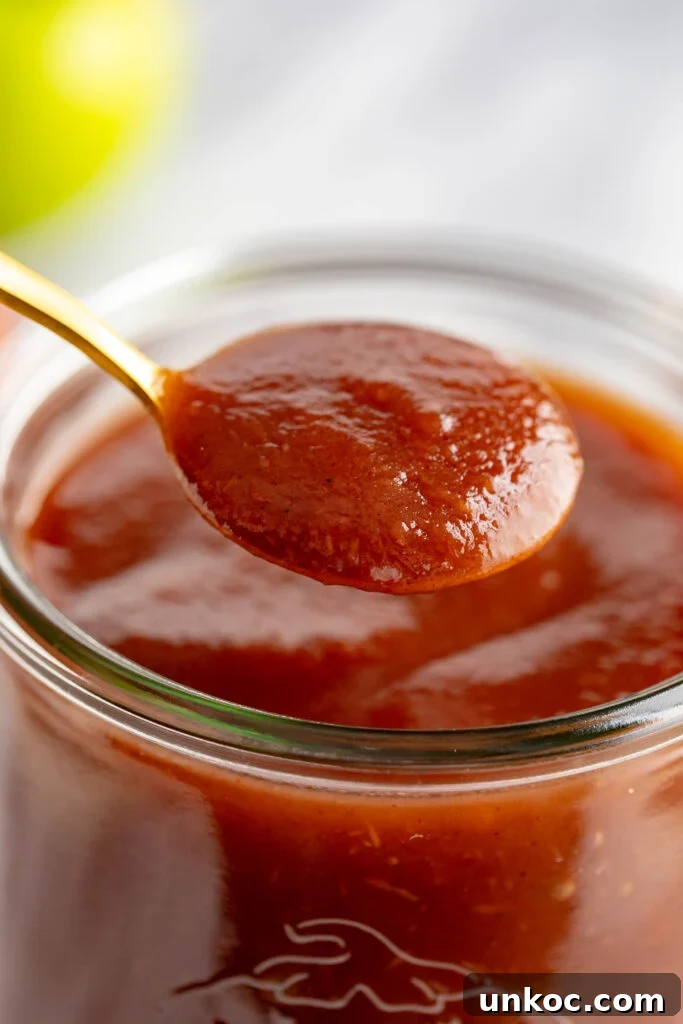 Instant Pot Apple Butter Recipe No Peeling Required 11 spoonful of apple butter scooped from jar