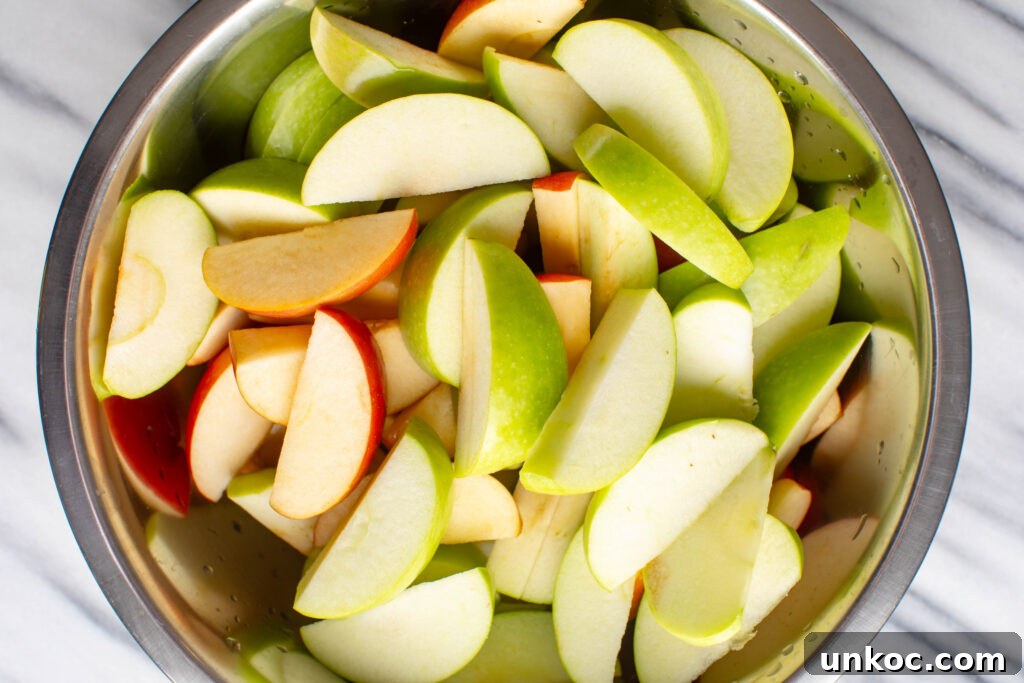 Instant Pot Apple Butter Recipe No Peeling Required 3 large mixing bowl filled with sliced red and green apples