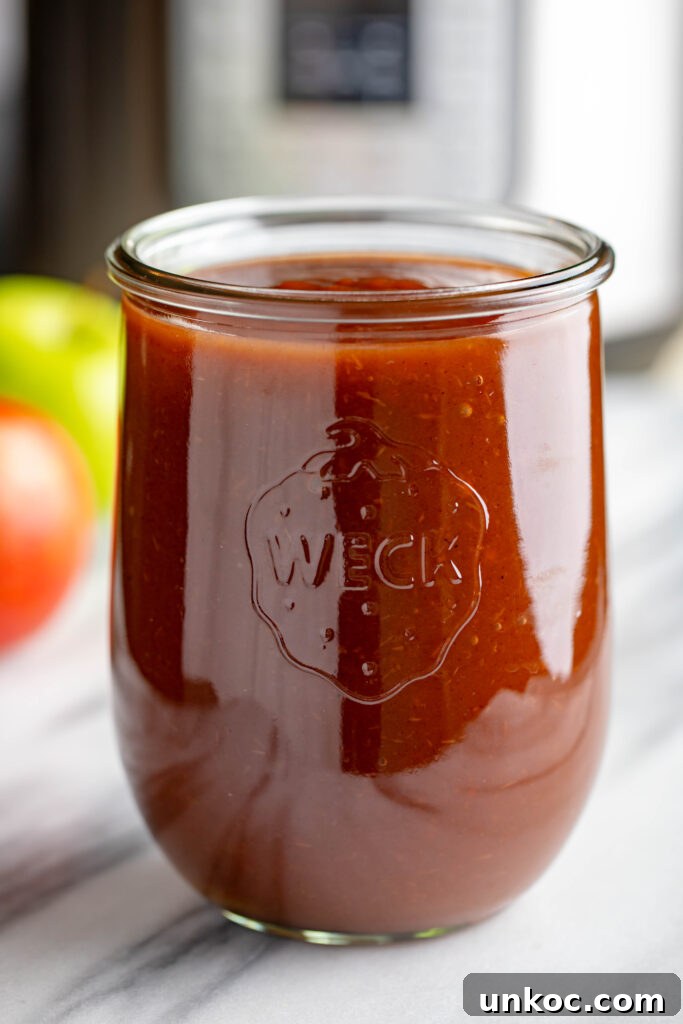 Instant Pot Apple Butter Recipe No Peeling Required 10 weck jar filled with apple butter made in an instapot